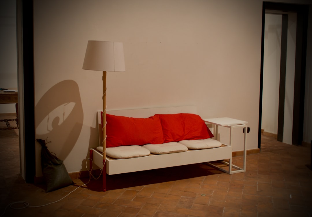 white-bench-with-red-cushions-and-floor-lamp-lrfcyoafeic